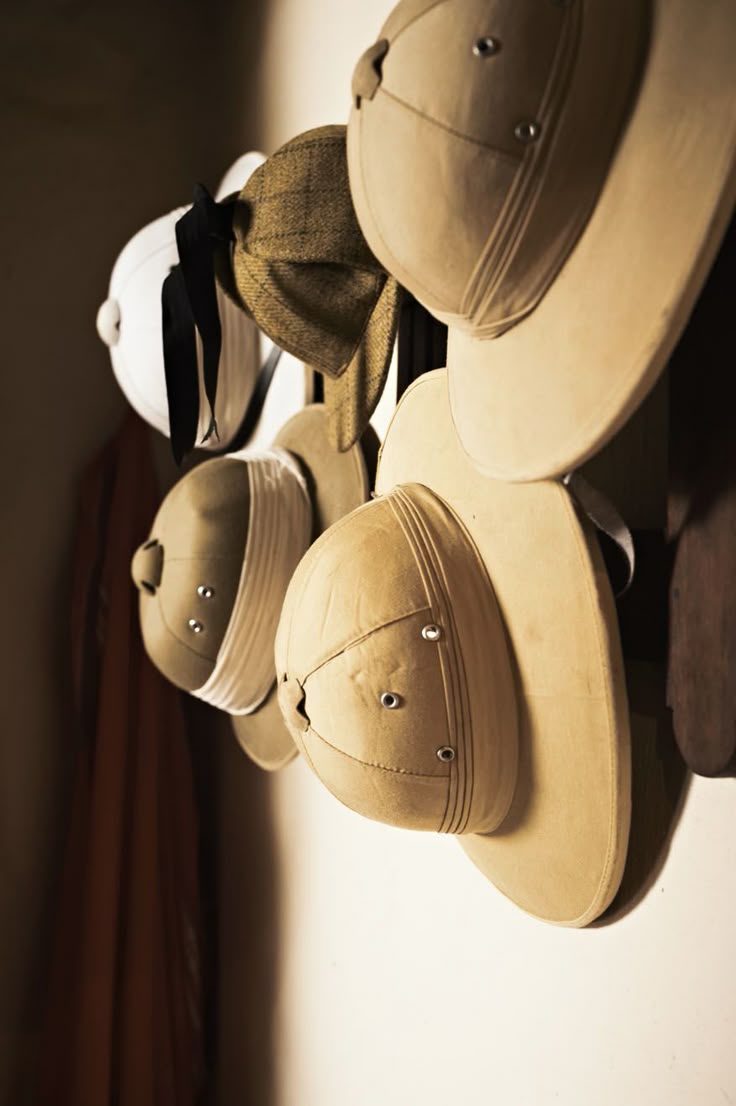 Safari hats hanging on wall